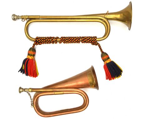 A brass trumpet, by Barretts, bound with red, yellow and black cords and tassels (slightly dented); a modern copper and brass