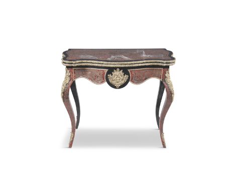 A 19TH CENTURY EBONY AND RED BOULLE FOLDING TOP CARD TABLE, of serpentine form, the apron with ormolu brass mount depicting a