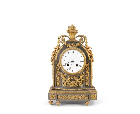 A FRENCH LOUIS PHILLIPE BRUSHED METAL AND ORMOLU MOUNTED CLOCK, the white enamel face, surmounted by cornucopia , floral swag