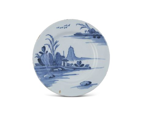 A RARE IRISH DELFTWARE DISH, Dublin c.1760, painted with Chinoiserie landscape, marked with number verso. 23cm diameter