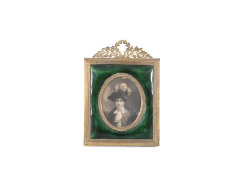 A FINE GILT METAL AND GUILLOCHE ENAMEL PHOTOGRAPH FRAME, surmounted with a laurel leaf cresting, with oval portrait reserve s