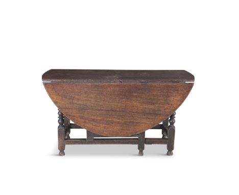 AN OAK DOUBLE DROP LEAF GATE LEG ACTION TABLE, 17th century, extending to oval form with single frieze drawer on block and bo