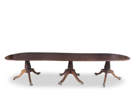 A GEORGE III MAHOGANY TRIPLE PILLAR, D-END DINING TABLE, extending to oval form, the solid top with moulded edge, supported o