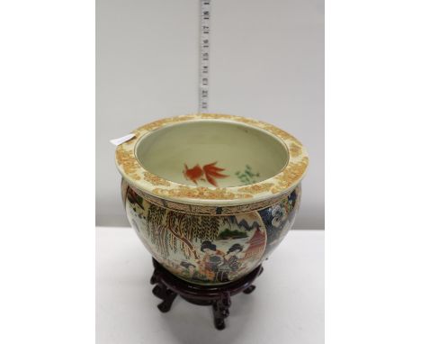A vintage Chinese ceramic fish bowl on wooden stand 