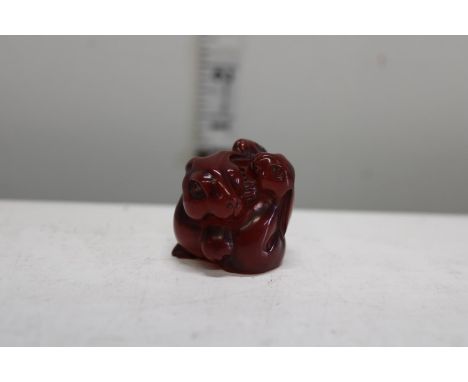 Amber Netsuke of hares signed 