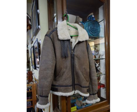 A gentleman's sheepskin three-quarter length coat; together with another sheepskin pilot style jacket by Cooper. Condition Re