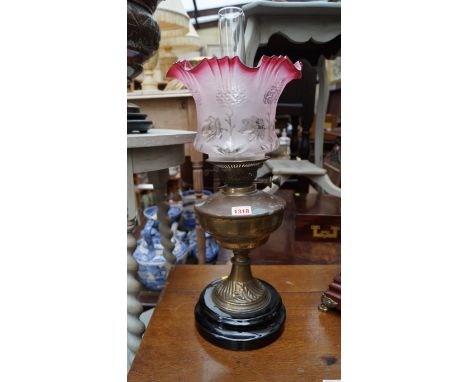 A Victorian brass oil lamp, (chip to base of shade). 