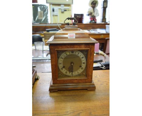 A Smiths 18th century style walnut mantel clock, with three train gong striking movement, height including handle 33.5cm.