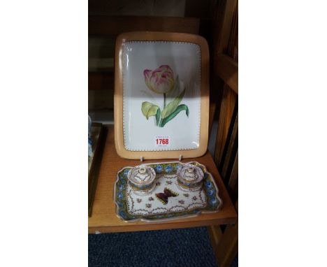 A Dresden porcelain twin inkwell stand, painted with a butterfly and flowers, 15.5cm wide, (chips to one cover); together wit