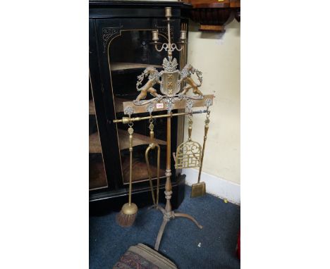 An antique brass tripod fire iron stand, with three branch candlestick surmount, 126.5cm high. 