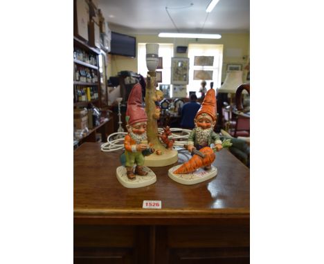 Two Goebel gnomes, largest 19.5cm high; together with another Goebel lampbase, height excluding fitting 22cm. 