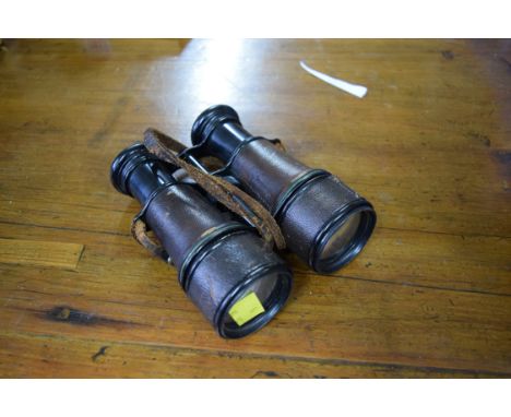 A pair of antique military field binoculars, with broad arrow.