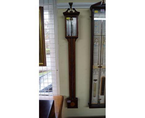 A reproduction mahogany and inlaid stick barometer.