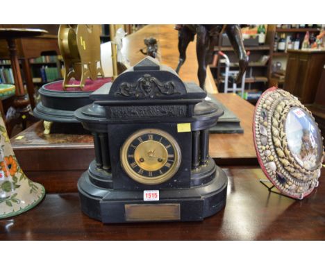 A late Victorian slate mantel clock, of architectural form, bearing gilt brass plaque inscribed '...to Mr Charles George Stre