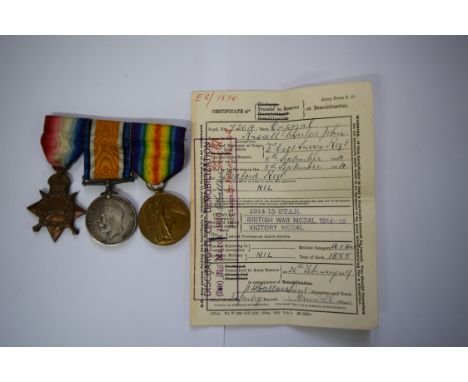 A World War I trio, to 7204 Cpl C J Russell E.Surr.R., comprising 1914-15 star; war medal; and victory medal; together with r