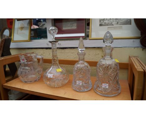 A silver mounted cut glass decanter and stopper; together with a graduated pair of cut glass decanters and stoppers; and anot