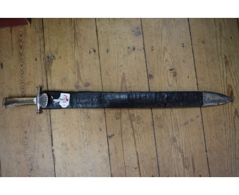 A Continental hunting sword and leather scabbard, the blade 49.5cm long. 