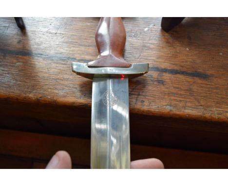 A German World War II period SA dagger and sheath, the blade inscribed 'Gebr.Bell.Solingen'.