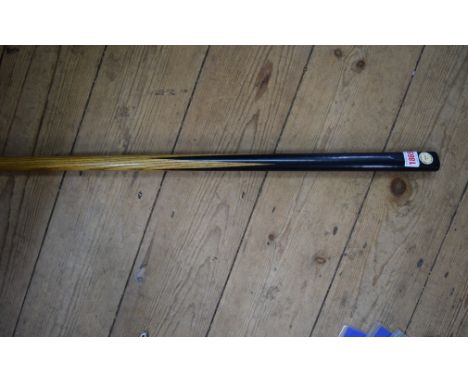 A vintage ash and ebony one piece billiard cue, bearing ivorine circular plaque inscribed 'The Inman Cue, 87 Wardour St...', 