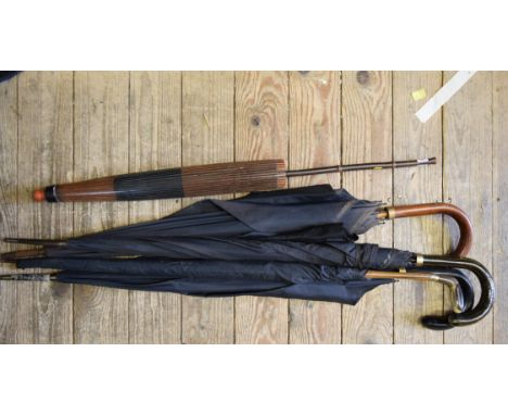 A Japanese bamboo handled parasol; together with four various vintage umbrellas. 