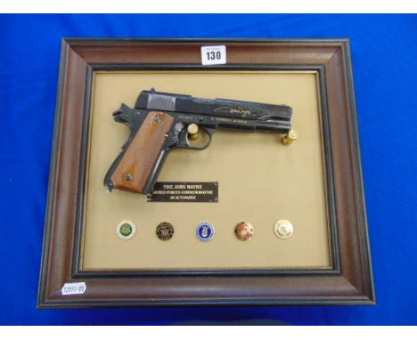 A Arm forces replica .45 gun, in display frame commemorative John Wayne