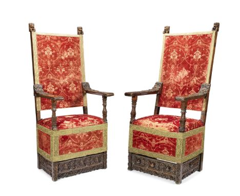 A pair of Italian carved walnut armchairs17th centuryUpholstered in Florentine voided red velvet of pomegranate design, circa