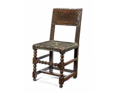 A mid-17th century oak and leather upholstered chairWith bobbin turned and block carved front legs joined by a barley twist s