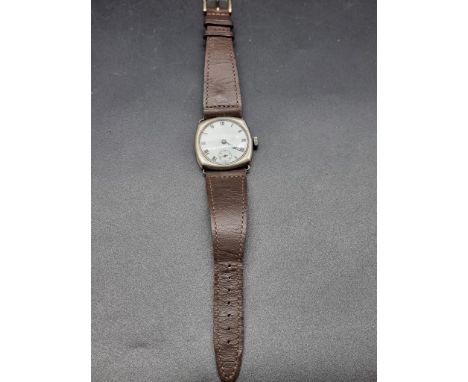 A circa 1930s Swiss white metal manual wind wristwatch,&nbsp;32mm, on a later leather strap. 