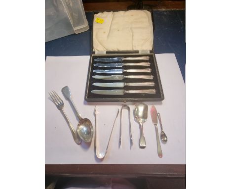 A cased set of six silver handled tea knives; together with a Victorian silver fiddle pattern caddy spoon; and other silver c