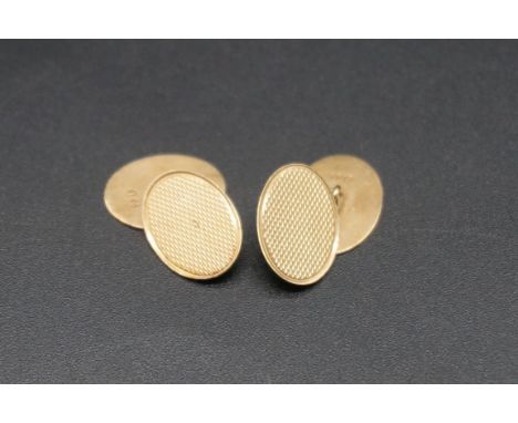 A pair of 9ct gold engine turned oval cufflinks, 3.6g. 