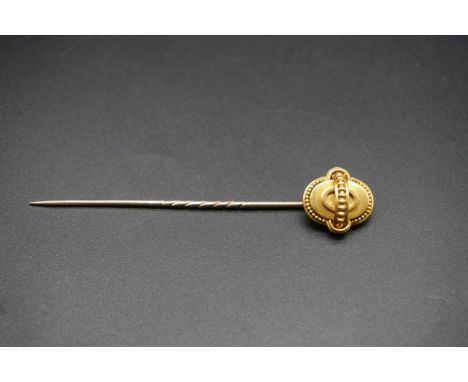 A yellow metal Etruscan revival memoriam stick pin,&nbsp;the reverse engraved and dated 1865, the pin is base metal, 84mm 