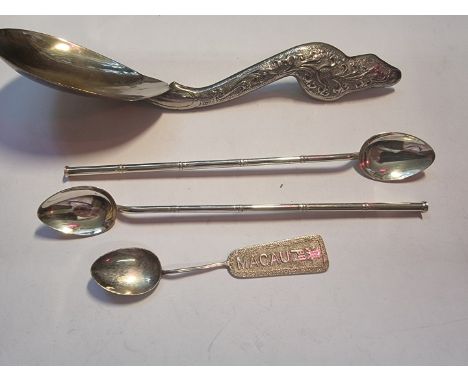 A pair of white metal mate spoons, stamped 'W K 925 Sterling', 19.5cm; together with a Macau white metal spoon; and a plated 