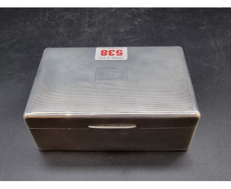 A silver rectangular cigarette box, having engine turned decoration to lid, London 1937, 14cm wide. 