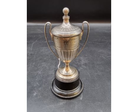 A silver miniature twin handled golf trophy cup and cover, by Walker &amp; Hall, Sheffield 1933, 13.5cm, 147g. 