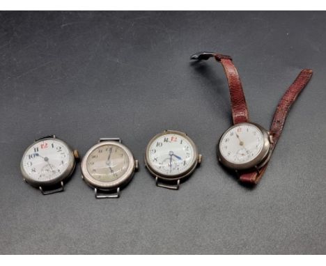 Three various WWI silver manual wind trench watches; together with another silver wristwatch. (4) 