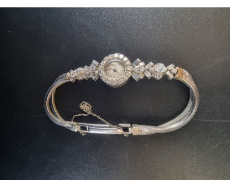 A vintage diamond encrusted manual wind wristwatch,&nbsp;21mm, set with 46 diamonds, stamped platinum, on bracelet stamped 9c