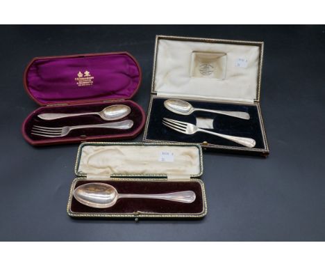 A cased silver christening fork and spoon; together with a cased silver christening spoon; and another cased silver christeni