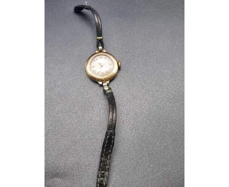 A vintage 18ct gold manual wind ladies wristwatch,&nbsp;25mm, on black leather strap.