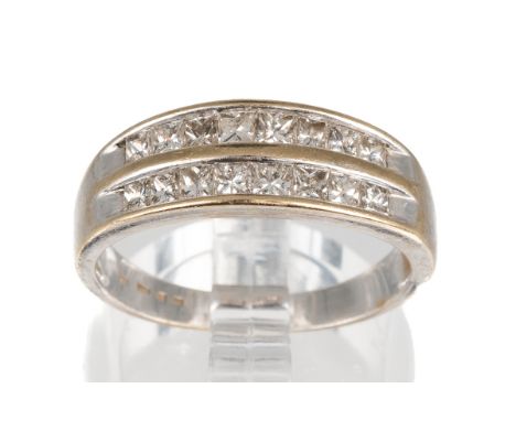 A white gold and diamond two-row ring, channel set with sixteen princess-cut diamonds, ring size O1/2, total gross weight app