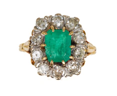 An 18ct yellow gold emerald and diamond cluster ring, the step-cut emerald surrounded by ten round diamonds, total diamond we