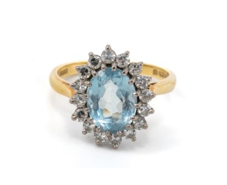 An 18ct yellow gold aquamarine and diamond oval cluster ring, the oval mixed-cut aquamarine surrounded by sixteen single-cut 