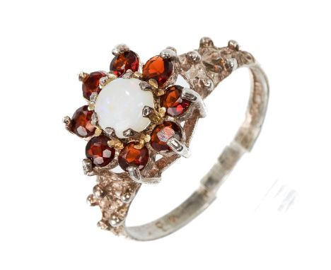 A silver opal and garnet ring, size L, total gross weight approx 1.9g Good condition, wear and tear commensurate with age