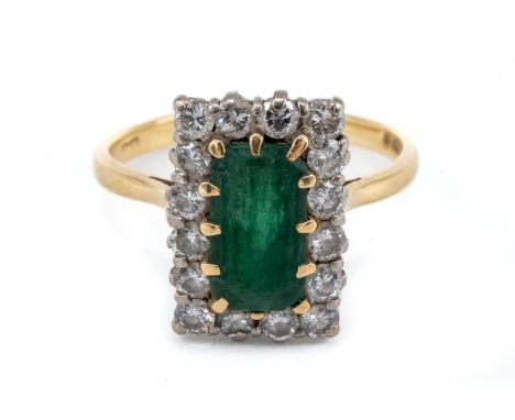 A yellow gold emerald and diamond rectangular cluster ring, the central step-cut emerald approx 10mm x 5.5mm, surrounded by s