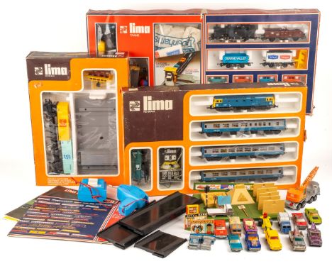 A collection of boxed Lima model trains and associated model railway furniture and die cast cars. Trains HO scale, circa 1970