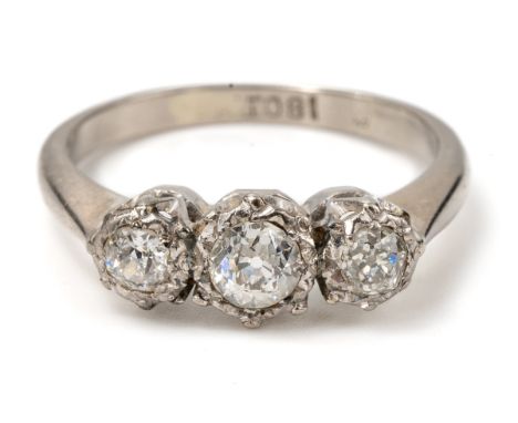 An 18ct white gold and diamond three-stone ring, illusion set old-cut diamonds, ring size M, total gross weight approx 3.4g G