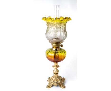 A Victorian oil lamp with gilt metal base, brass fittings, amber and green body and green etched shade. Approx. height 62cm i