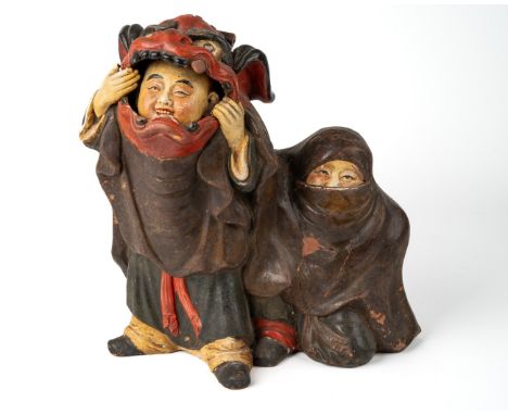 A Chinese terracotta figure of boys playing in Chinese dragon costume, character marks to back, hand painted, 25cm high, 24cm