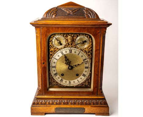 An Edwardian bracket clock, in honey coloured oak, gilt metal detail to face, key to front and back doors, presentation plaqu