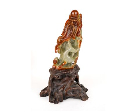 A Chinese carved jade figure, depicting an elder, approx 12cm high, approx 277g, boxed with paperwork and hardwood stand 
