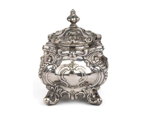 A Victorian silver-plated tea caddy, of shaped square form cast with foliate scrolls, the cover with knop finial, four scroll